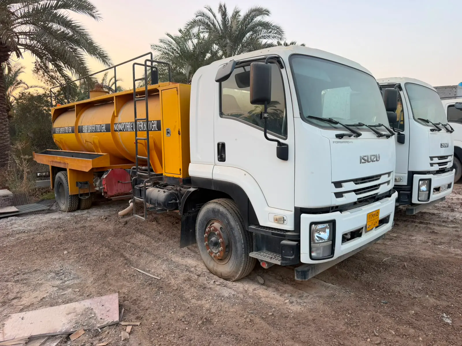 Waste-water and non-potable water tankers at sunset