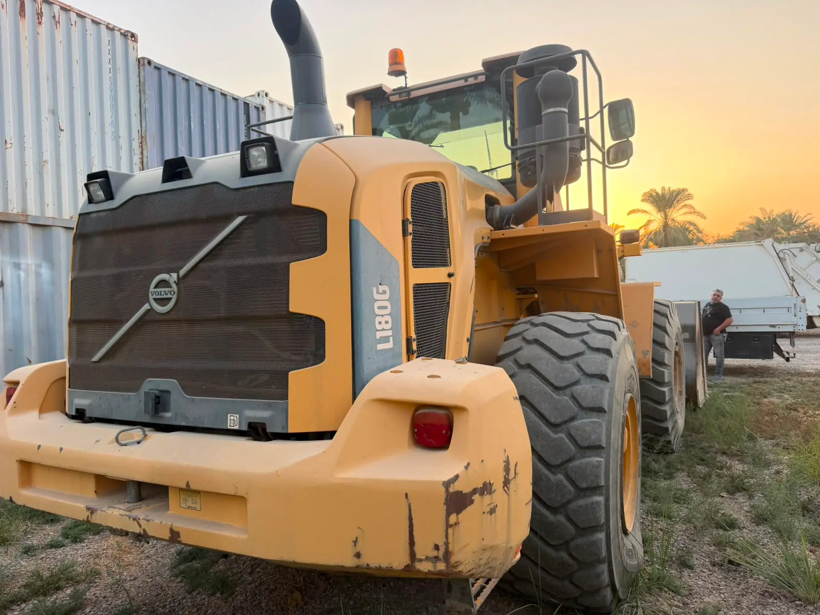 Volvo wheel loader at sunset beside the container yard