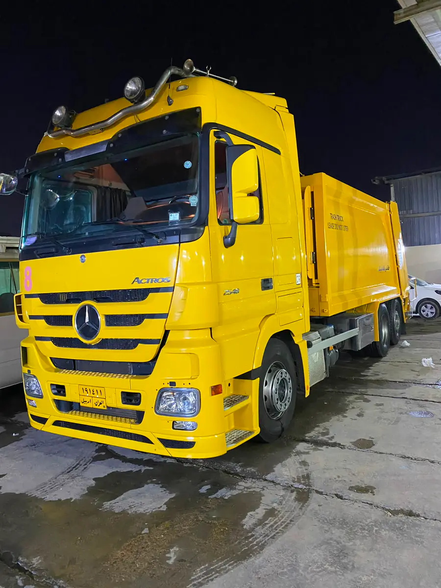 Yellow Mercedes-Benz Actros refuse compactor