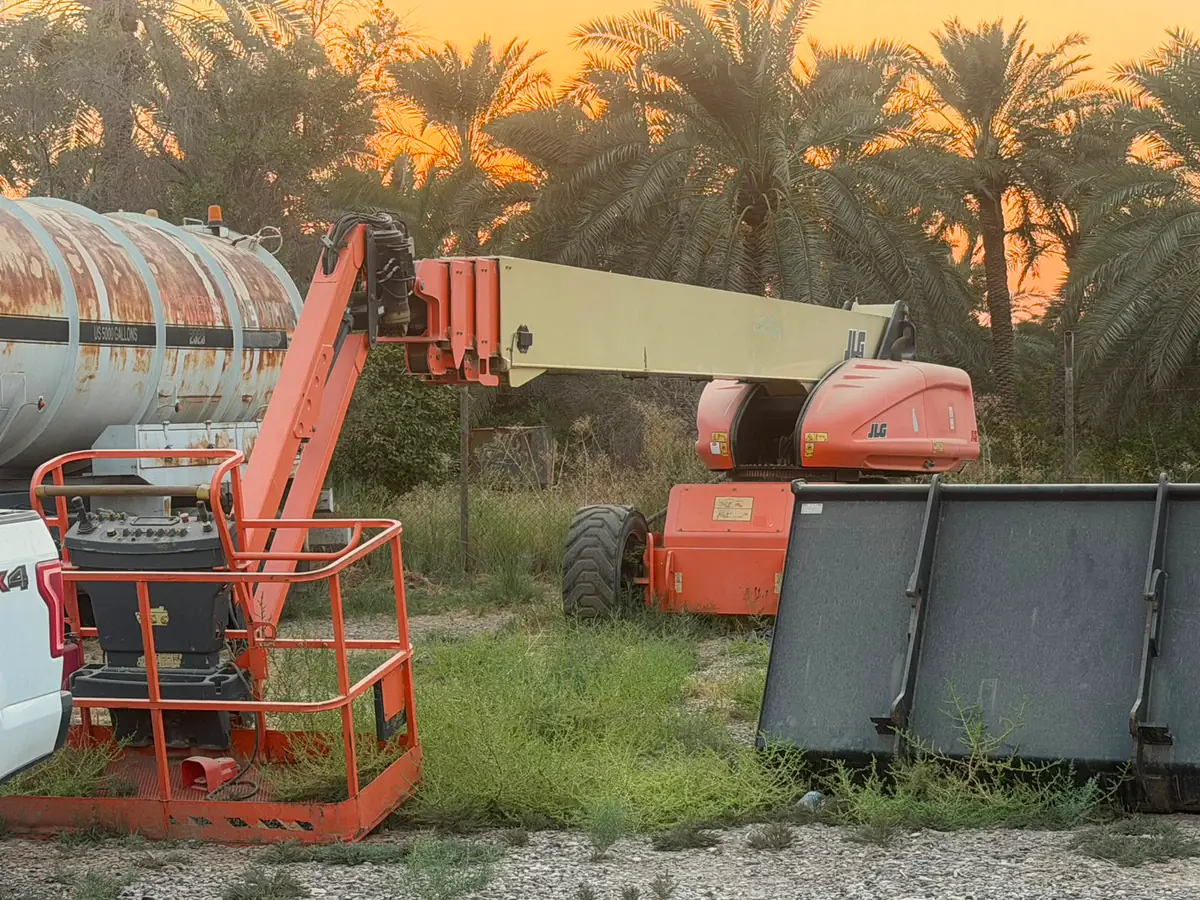 JLG telescopic boom lift at sunset