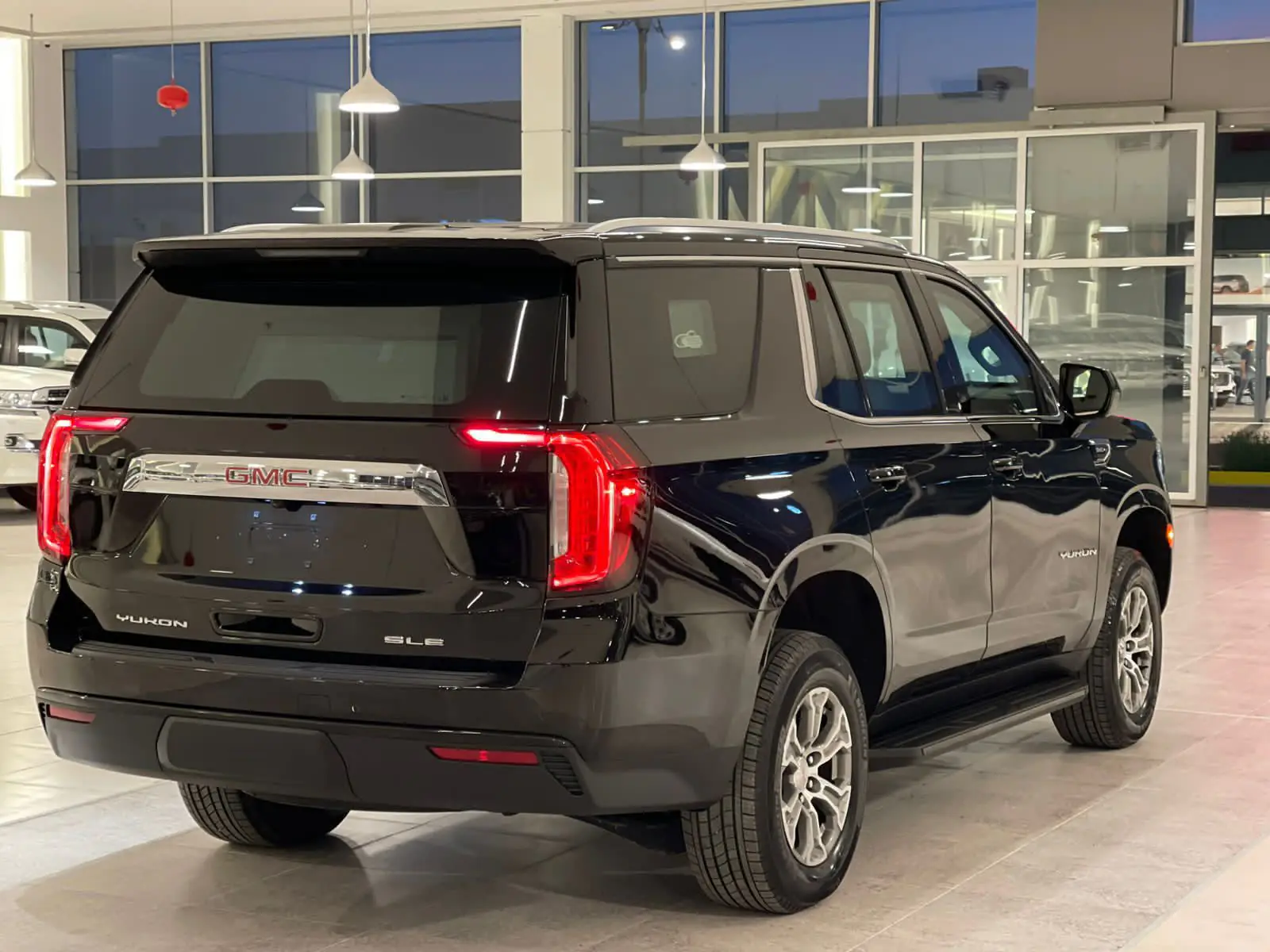 Black GMC Yukon SLE in a showroom