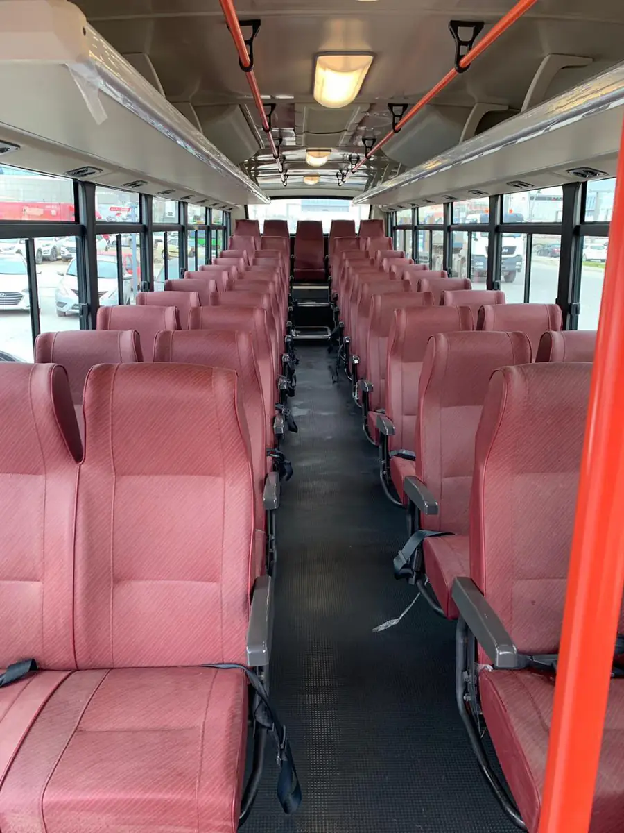 Interior of a crew bus with rows of seats